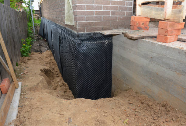 SJ Waterproofing Pros technician performing targeted Wet Basement Repair assessment in Lancaster, KY